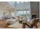 Sun-filled living room featuring hardwood floors, a stone fireplace, and large sliding doors with great backyard views at 3965 E Sierra Vista Dr, Paradise Valley, AZ 85253