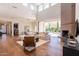 Bright living room with high ceilings, fireplace, hardwood floors, and sliding glass doors to backyard at 3965 E Sierra Vista Dr, Paradise Valley, AZ 85253