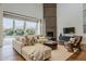 Bright living room with plush seating, a sleek fireplace, and sliding glass doors overlooking the lush backyard at 3965 E Sierra Vista Dr, Paradise Valley, AZ 85253