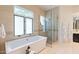 Luxury bathroom with soaking tub, frameless shower, and neutral tile at 3965 E Sierra Vista Dr, Paradise Valley, AZ 85253