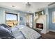 Bright bedroom with fireplace, king-size bed, and access to private balcony at 10287 E Diamond Rim Dr, Scottsdale, AZ 85255