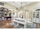 Open dining area with a rustic table and view of a pool table at 10287 E Diamond Rim Dr, Scottsdale, AZ 85255