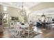 Elegant dining room with a large table, chandelier, and access to the kitchen at 10287 E Diamond Rim Dr, Scottsdale, AZ 85255