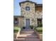 Front entrance of a charming stone house with a herringbone brick walkway at 10287 E Diamond Rim Dr, Scottsdale, AZ 85255