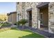 Stone exterior with covered patio and manicured lawn at 10287 E Diamond Rim Dr, Scottsdale, AZ 85255