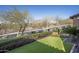 Landscaped front yard with artificial turf and mountain views at 10287 E Diamond Rim Dr, Scottsdale, AZ 85255