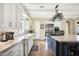 Modern kitchen with white cabinets, a blue island, and decorative backsplash at 10287 E Diamond Rim Dr, Scottsdale, AZ 85255