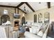 Cozy living room featuring a stone fireplace and large windows at 10287 E Diamond Rim Dr, Scottsdale, AZ 85255
