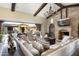 Spacious living room with stone fireplace and backyard access at 10287 E Diamond Rim Dr, Scottsdale, AZ 85255