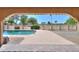 An arched view of the pool with a golf course in the background at 2119 N Lake Shore Dr, Casa Grande, AZ 85122