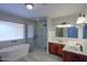 Bright bathroom with dual vanity, soaking tub, and glass shower at 2119 N Lake Shore Dr, Casa Grande, AZ 85122