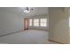 Large open bedroom with wood trim doorway and window with vertical blinds at 2119 N Lake Shore Dr, Casa Grande, AZ 85122