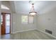 Dining room with wood-look tile flooring, a modern chandelier, and bright natural light at 2119 N Lake Shore Dr, Casa Grande, AZ 85122