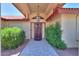 Inviting front entrance with stone walkway, custom door, and decorative hanging light fixture at 2119 N Lake Shore Dr, Casa Grande, AZ 85122