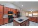 Kitchen with an island, modern appliances, and wood cabinets at 2119 N Lake Shore Dr, Casa Grande, AZ 85122