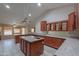 Bright, open kitchen with granite countertops, wood cabinets, and an island at 2119 N Lake Shore Dr, Casa Grande, AZ 85122