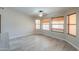 Bright living room with many windows, wood-look tile flooring, and a ceiling fan at 2119 N Lake Shore Dr, Casa Grande, AZ 85122