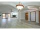 Open-concept living area with tile floors, fireplace, and arched doorway to other rooms at 2119 N Lake Shore Dr, Casa Grande, AZ 85122