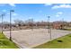 Outdoor basketball court with ample lighting, located in a well-maintained community park at 37607 W Padilla St, Maricopa, AZ 85138