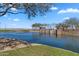Scenic view of a tranquil pond with lush green banks and covered gazebos, perfect for relaxation at 37607 W Padilla St, Maricopa, AZ 85138