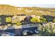 Expansive desert home with lush landscaping featuring a circular driveway and views of mountains in the distance at 10537 N Crestview Dr, Fountain Hills, AZ 85268