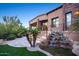 Lush backyard featuring a soothing rock waterfall, mature palm trees, and outdoor entertaining area at 10537 N Crestview Dr, Fountain Hills, AZ 85268