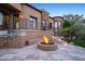 Outdoor kitchen and fire pit complement this beautiful backyard with pavers and desert landscaping at 10537 N Crestview Dr, Fountain Hills, AZ 85268