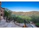 Beautiful backyard with stone patio, fire pit, wrought iron railings, and desert landscape views at 10537 N Crestview Dr, Fountain Hills, AZ 85268