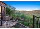 Inviting backyard features a rock water feature, desert landscaping, and beautiful wrought iron railings at 10537 N Crestview Dr, Fountain Hills, AZ 85268