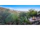 Lush backyard with stone patio, fire pit, and desert landscaping providing privacy and scenic views at 10537 N Crestview Dr, Fountain Hills, AZ 85268