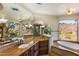Large primary bathroom with dual vanities, soaking tub, walk-in shower, and beautiful outdoor views at 10537 N Crestview Dr, Fountain Hills, AZ 85268