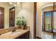 A bathroom features granite counters and a wood framed mirror and opens to the balcony at 10537 N Crestview Dr, Fountain Hills, AZ 85268