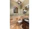 Bathroom with marble floors, a wood vanity, a toilet, and dark fixtures at 10537 N Crestview Dr, Fountain Hills, AZ 85268