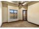 A bedroom features a ceiling fan and a door to the outdoor balcony with a beautiful view at 10537 N Crestview Dr, Fountain Hills, AZ 85268