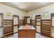 Large walk-in closet with custom built-in wood shelving and center island at 10537 N Crestview Dr, Fountain Hills, AZ 85268