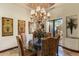 Formal dining room with a glass table, decorative chandelier, and views of the outdoor patio at 10537 N Crestview Dr, Fountain Hills, AZ 85268