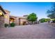 Long brick driveway leading to a stone home with lush landscaping at 10537 N Crestview Dr, Fountain Hills, AZ 85268