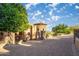 Circular stone facade with lush landscaping, iron railing, and paver driveway creates inviting curb appeal at 10537 N Crestview Dr, Fountain Hills, AZ 85268