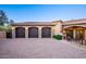 Three-car garage with stone accents and a brick driveway at 10537 N Crestview Dr, Fountain Hills, AZ 85268