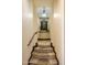 Hallway and stairs with stone floors, wood trim, and decorative alcove at 10537 N Crestview Dr, Fountain Hills, AZ 85268