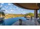 Infinity pool with waterfall feature overlooks picturesque desert landscape at 10537 N Crestview Dr, Fountain Hills, AZ 85268