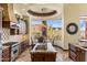 Bright kitchen with a granite island, breakfast nook with view, and professional appliances at 10537 N Crestview Dr, Fountain Hills, AZ 85268