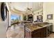 Open kitchen with granite countertops, custom cabinetry, and seamless living room views at 10537 N Crestview Dr, Fountain Hills, AZ 85268