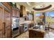 Gourmet kitchen with custom wood cabinets, granite counters, and high-end stainless steel appliances at 10537 N Crestview Dr, Fountain Hills, AZ 85268