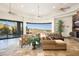 Spacious living room boasts expansive windows with stunning views, stone fireplace, and designer furnishings at 10537 N Crestview Dr, Fountain Hills, AZ 85268
