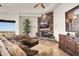 Comfortable living room showcasing a stone fireplace, entertainment center, and plush seating at 10537 N Crestview Dr, Fountain Hills, AZ 85268