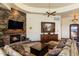 Warm living room with a stone fireplace, rich wood accents, and ample seating at 10537 N Crestview Dr, Fountain Hills, AZ 85268
