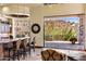 Spacious living area featuring a cozy seating area, backyard access, and kitchen view at 10537 N Crestview Dr, Fountain Hills, AZ 85268
