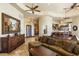 Open-concept living room featuring a coffered ceiling, tile flooring, and seamless flow to the kitchen at 10537 N Crestview Dr, Fountain Hills, AZ 85268