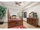 The main bedroom features a four poster bed, wood floors, a ceiling fan, and a window at 10537 N Crestview Dr, Fountain Hills, AZ 85268
